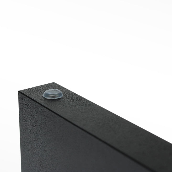 Detail of rubber leg cap on black-finish SPENVI manicure arm rest for stability and surface protection.