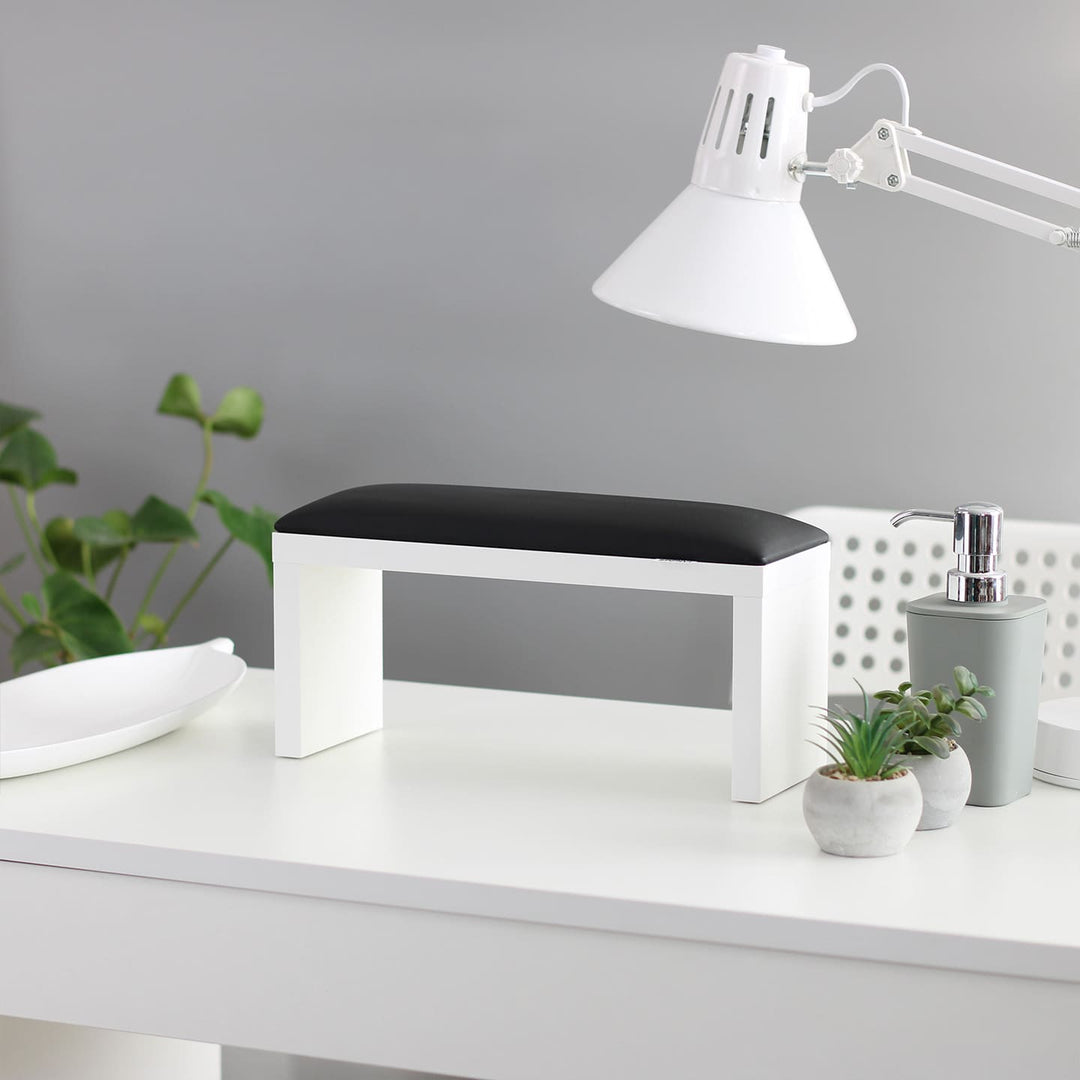 SPENVI Classic manicure arm rest with black leather cushion and white-finish legs on a modern salon desk. #color_black