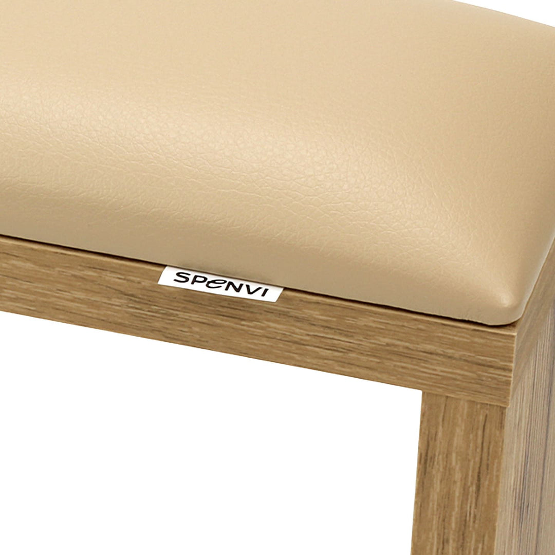Close-up of SPENVI Classic manicure arm rest with beige leather cushion and oak-finish wooden base. #color_coffee-milk