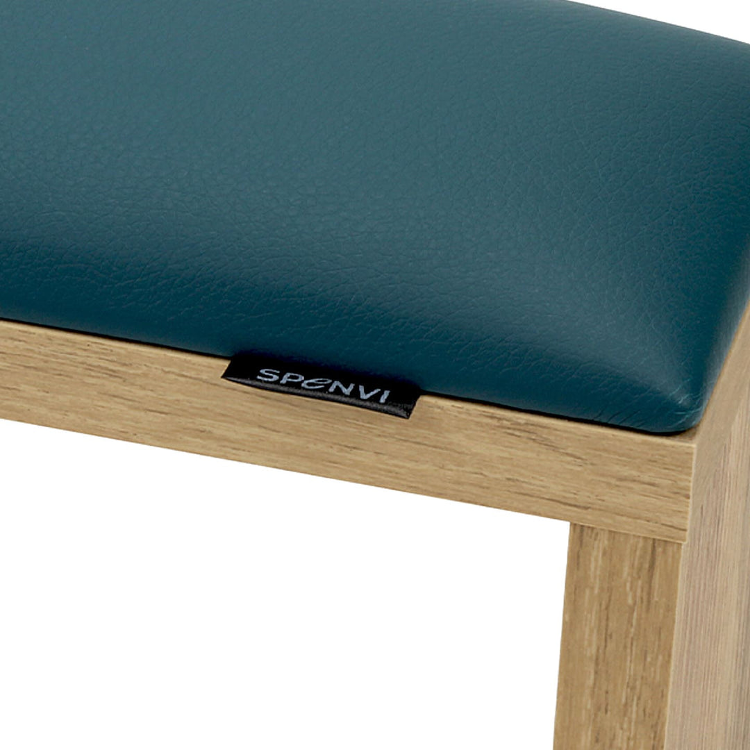 Close-up of SPENVI Classic manicure arm rest with dark green leather cushion and oak-finish wooden base. #color_dark-green