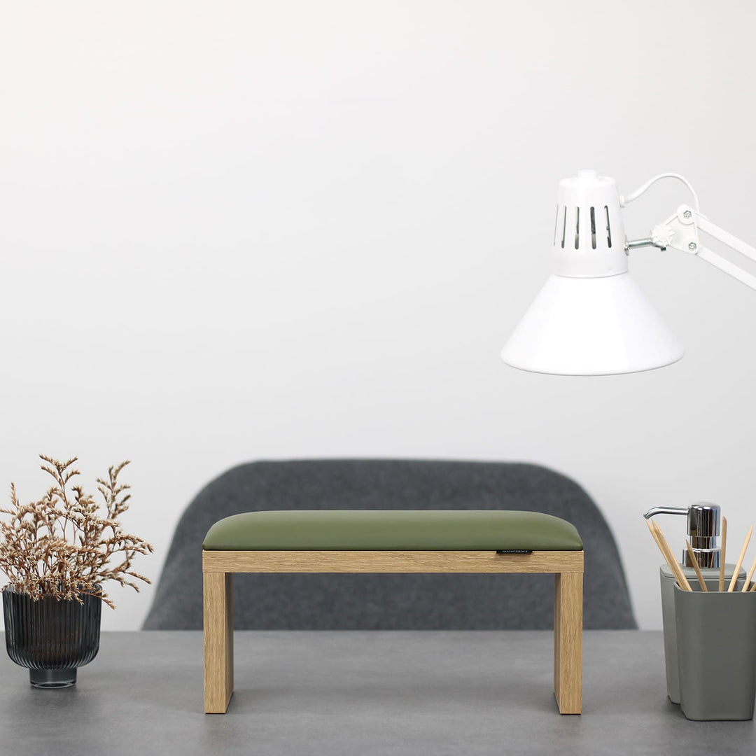 SPENVI Classic manicure arm rest with khaki leather cushion and oak-finish legs on modern salon desk under white lamp. #color_khaki