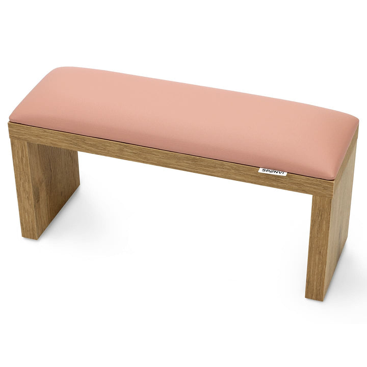 SPENVI Classic manicure arm rest with light pink leather cushion and oak-finish wooden legs, displayed on a white background. #color_light-pink