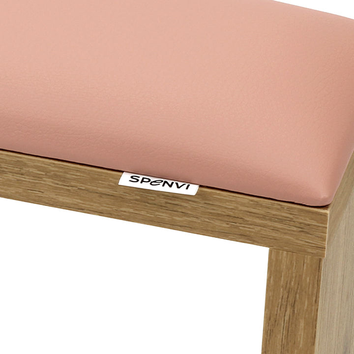 Close-up of SPENVI Classic manicure arm rest with light pink leather cushion and oak-finish wooden base. #color_light-pink