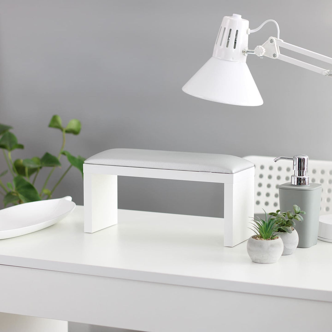 SPENVI Classic manicure arm rest with silver leather cushion and white-finish legs on a modern salon desk. #color_silver