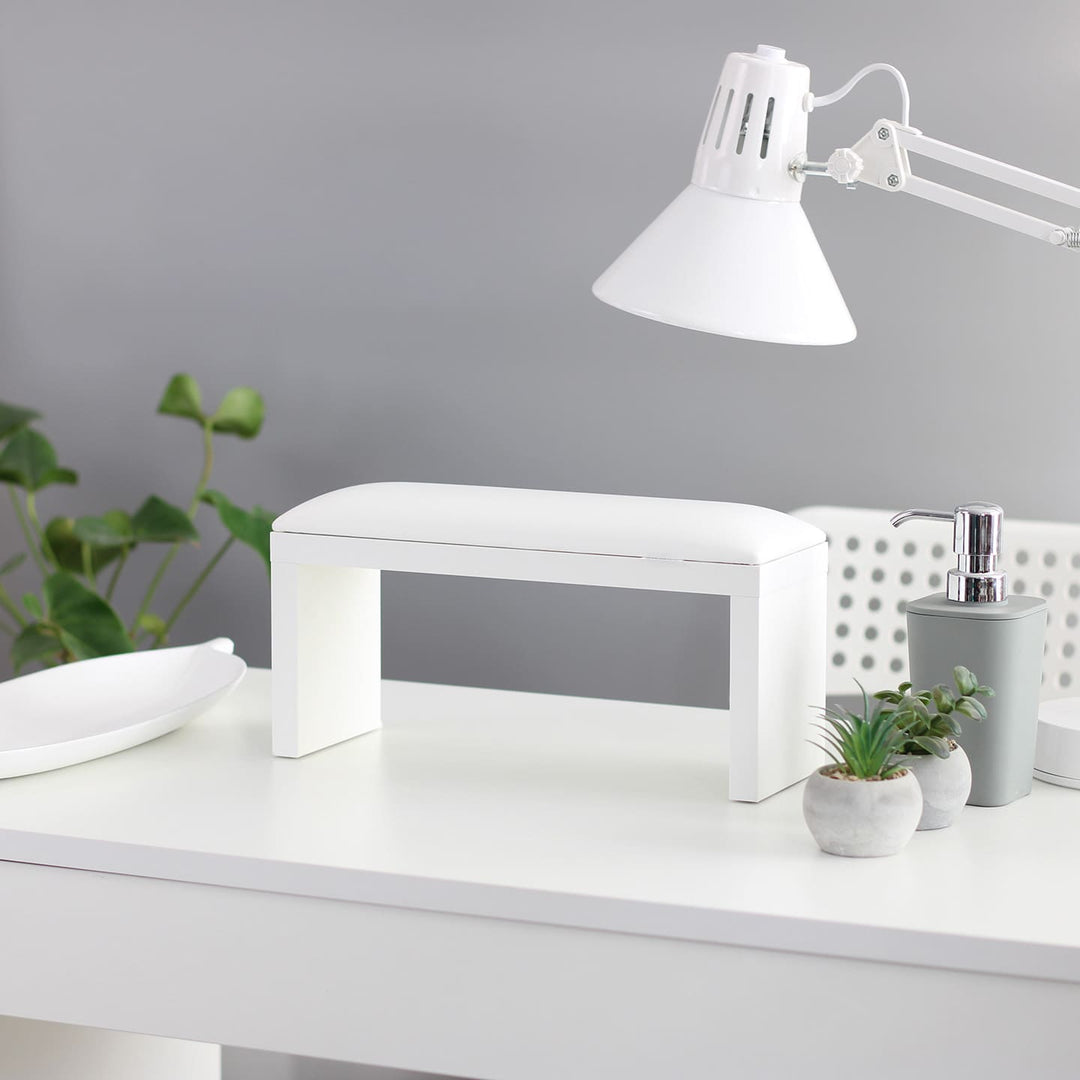 SPENVI Classic manicure arm rest with white leather cushion and white-finish legs on a modern salon desk. #color_white