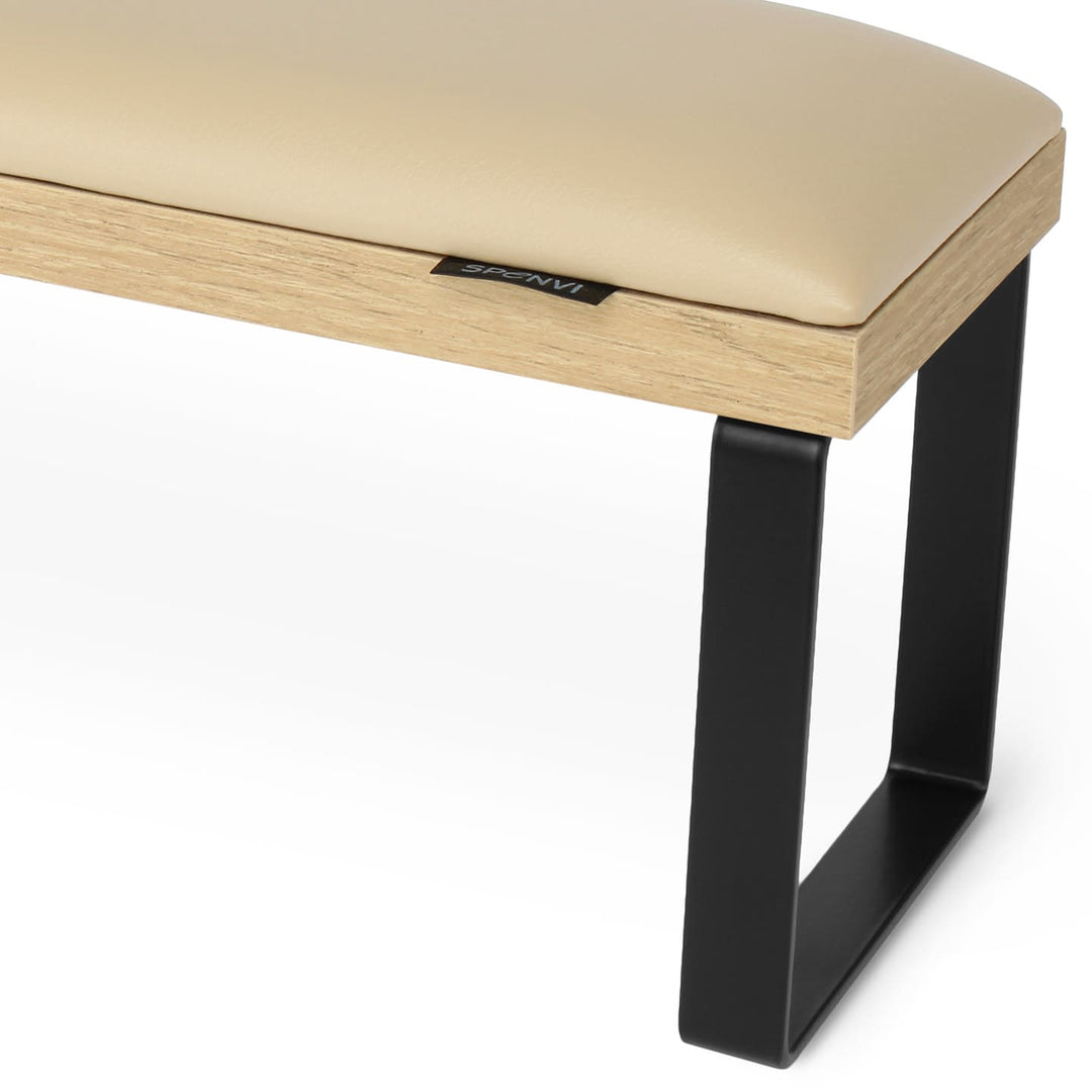 Side view of SPENVI Loft arm rest showing smooth beige leather cushion, oak-finish base, and black metal legs. #color_coffee-milk