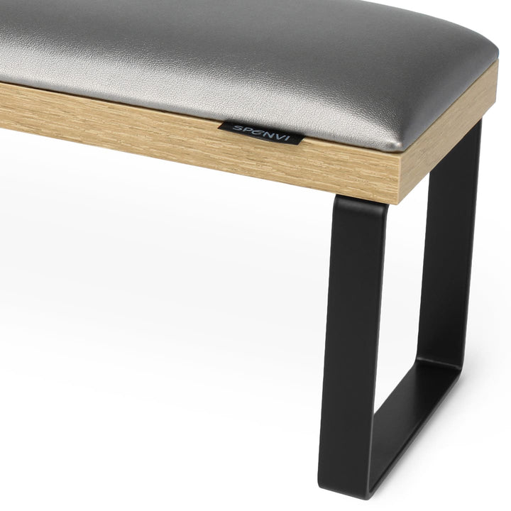 Side view of SPENVI Loft arm rest showing smooth graphite leather cushion, oak-finish base, and black metal legs. #color_graphite