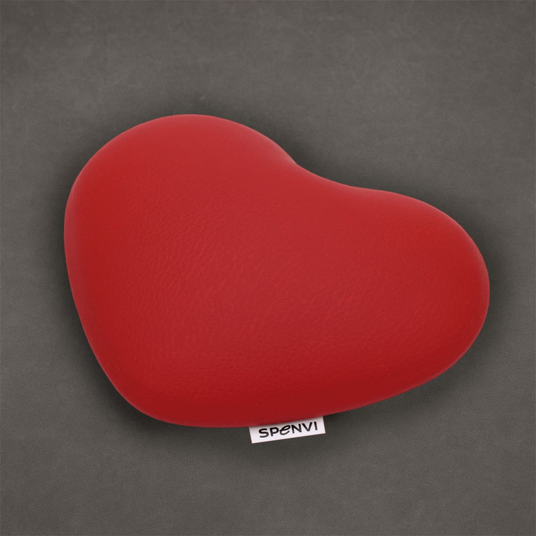 Red heart-shaped SPENVI nail tech elbow cushion made of soft leather on a textured grey background. #color_red