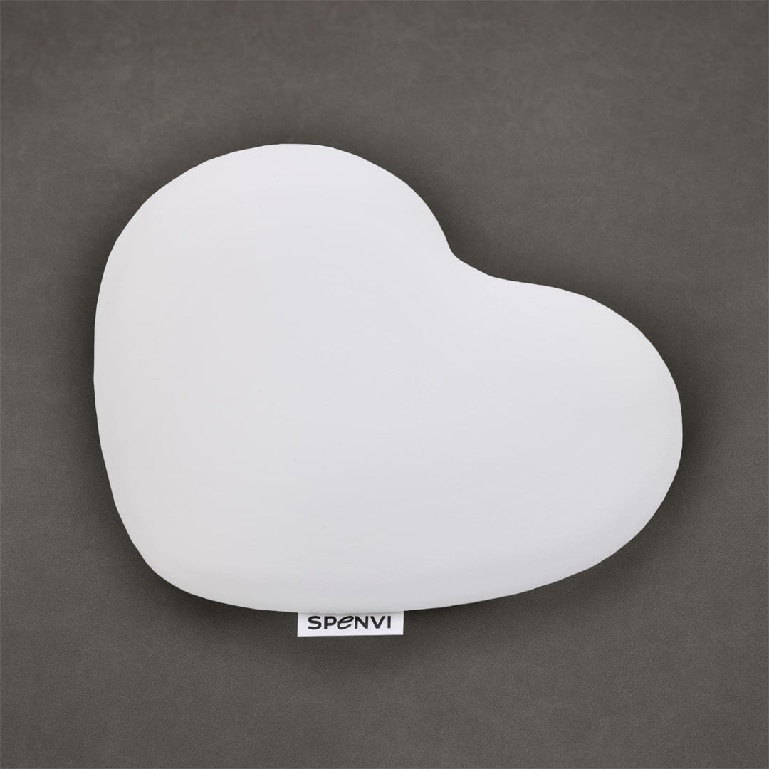 White heart-shaped SPENVI nail tech elbow cushion made of soft leather on a textured grey background. #color_white