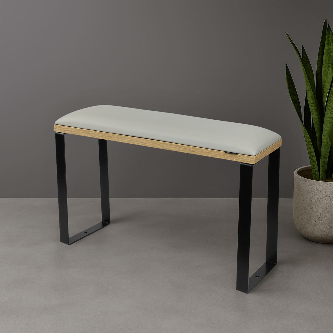 SPENVI Loft pedicure footrest with light gray leather cushion, oak-finish base, and black metal legs styled in modern salon interior with plant. #color_cloud