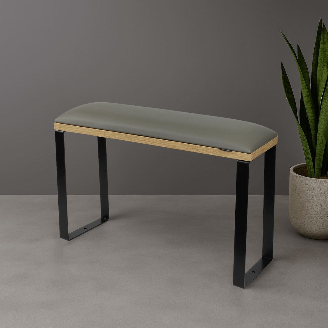 SPENVI Loft pedicure footrest with gray leather cushion, oak-finish base, and black metal legs styled in modern salon interior with plant. #color_gray