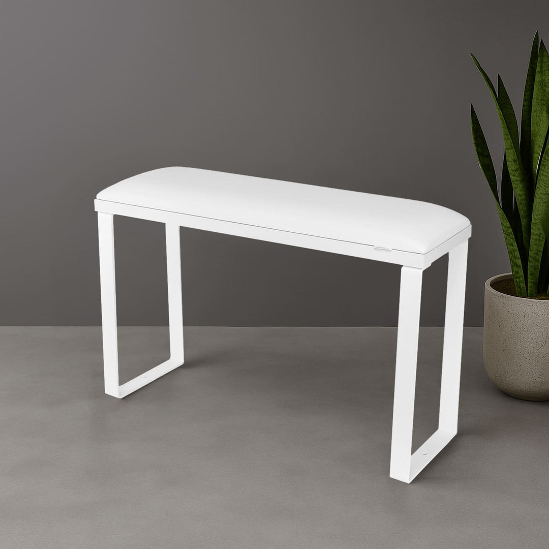 SPENVI Loft pedicure footrest with white leather cushion, white base, and white metal legs styled in modern salon interior with plant. #color_white